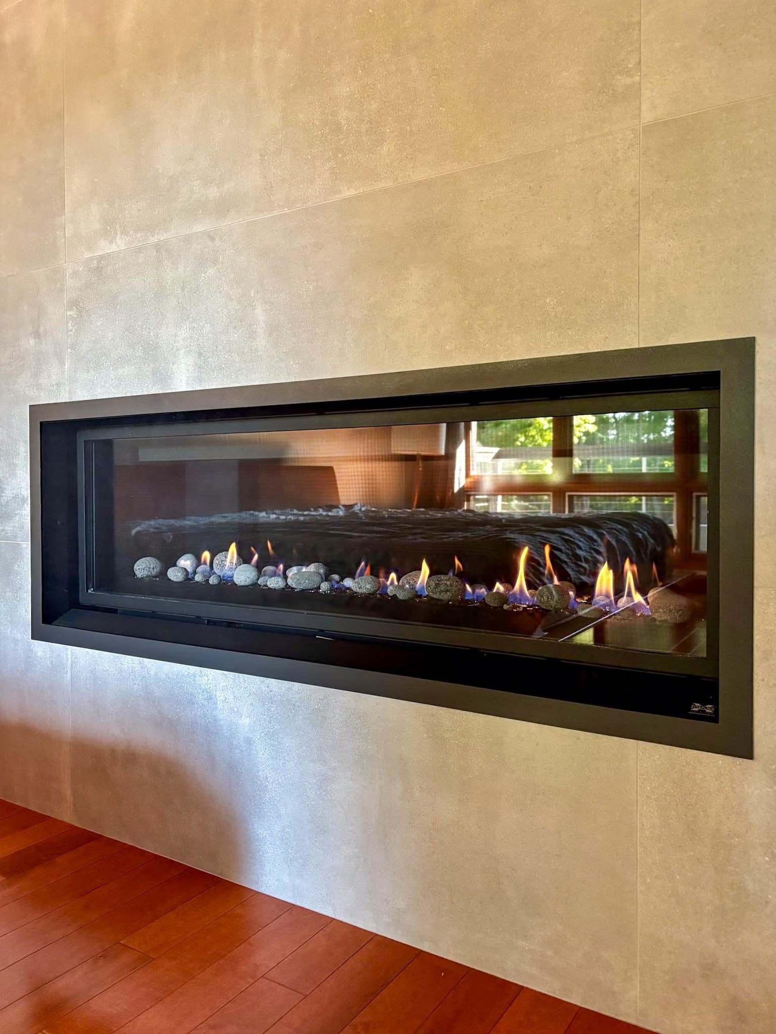 Floor-to-ceiling tile fireplace surround with linear gas insert Carmichael remodel