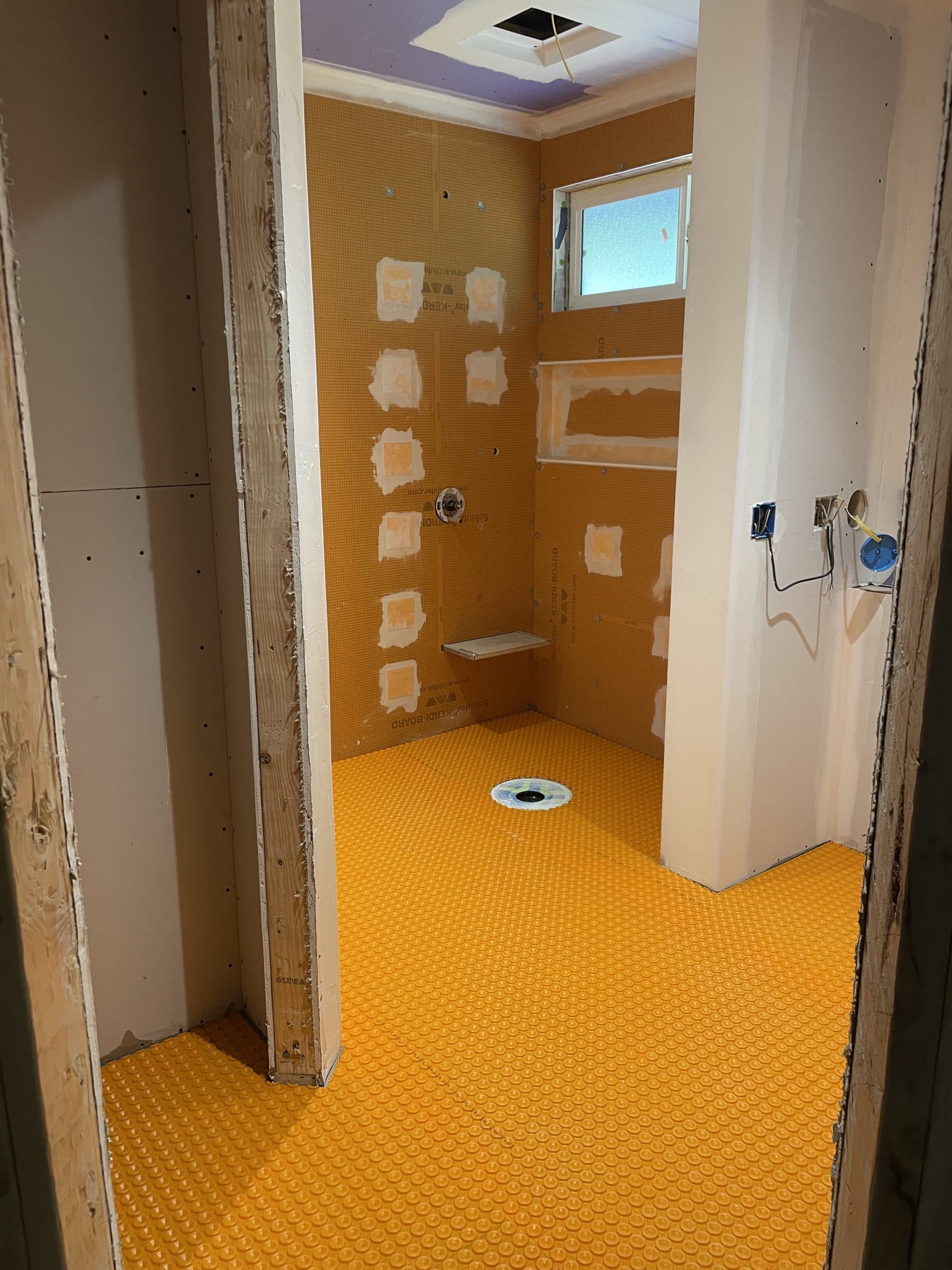 Radiant heat membrane around plumbing rough-in Sacramento bathroom renovation