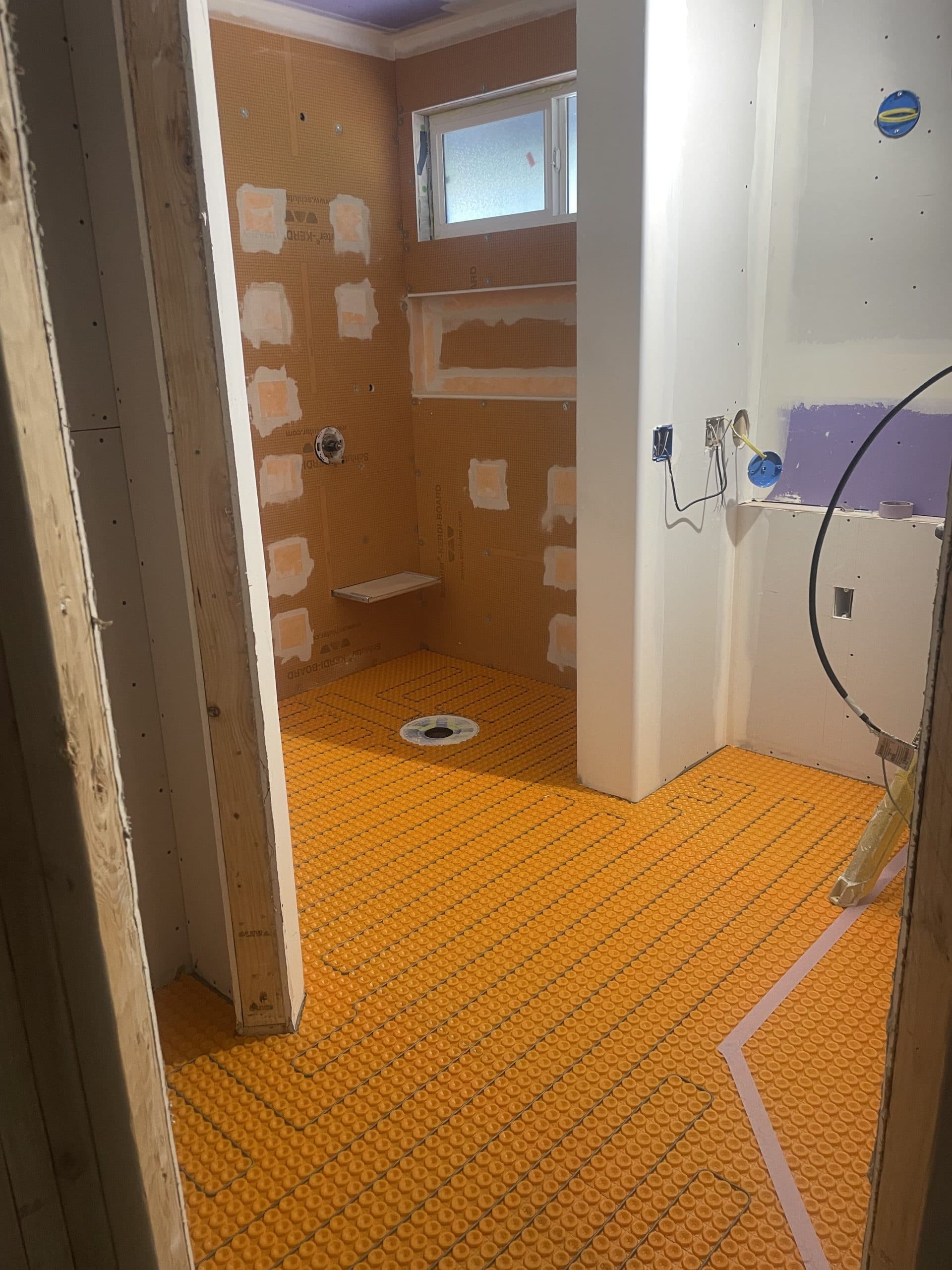Orange Ditra-Heat floor mat installation in Carmichael home bathroom remodel