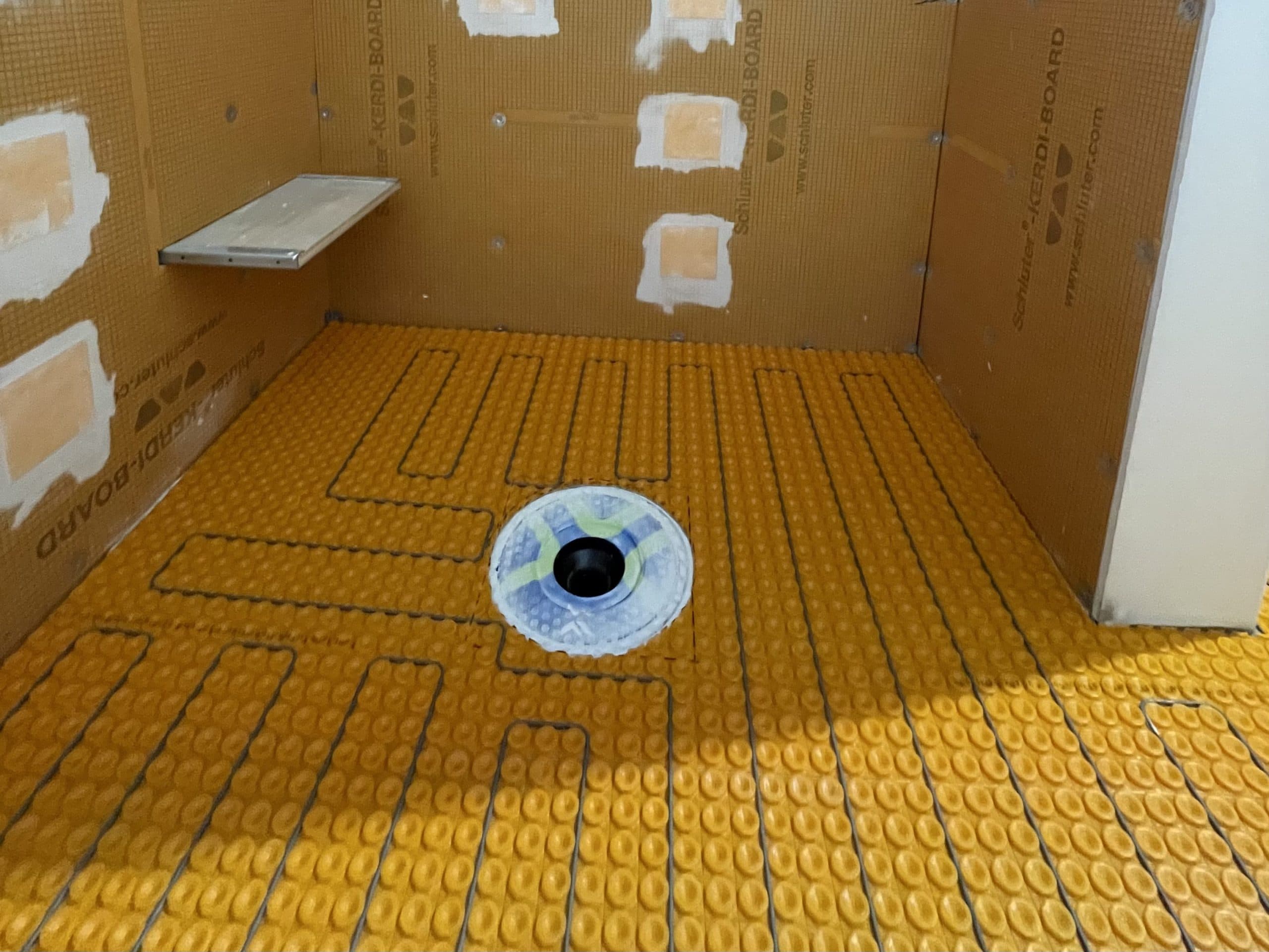 Heated floor membrane on subfloor during Carmichael remodeling project