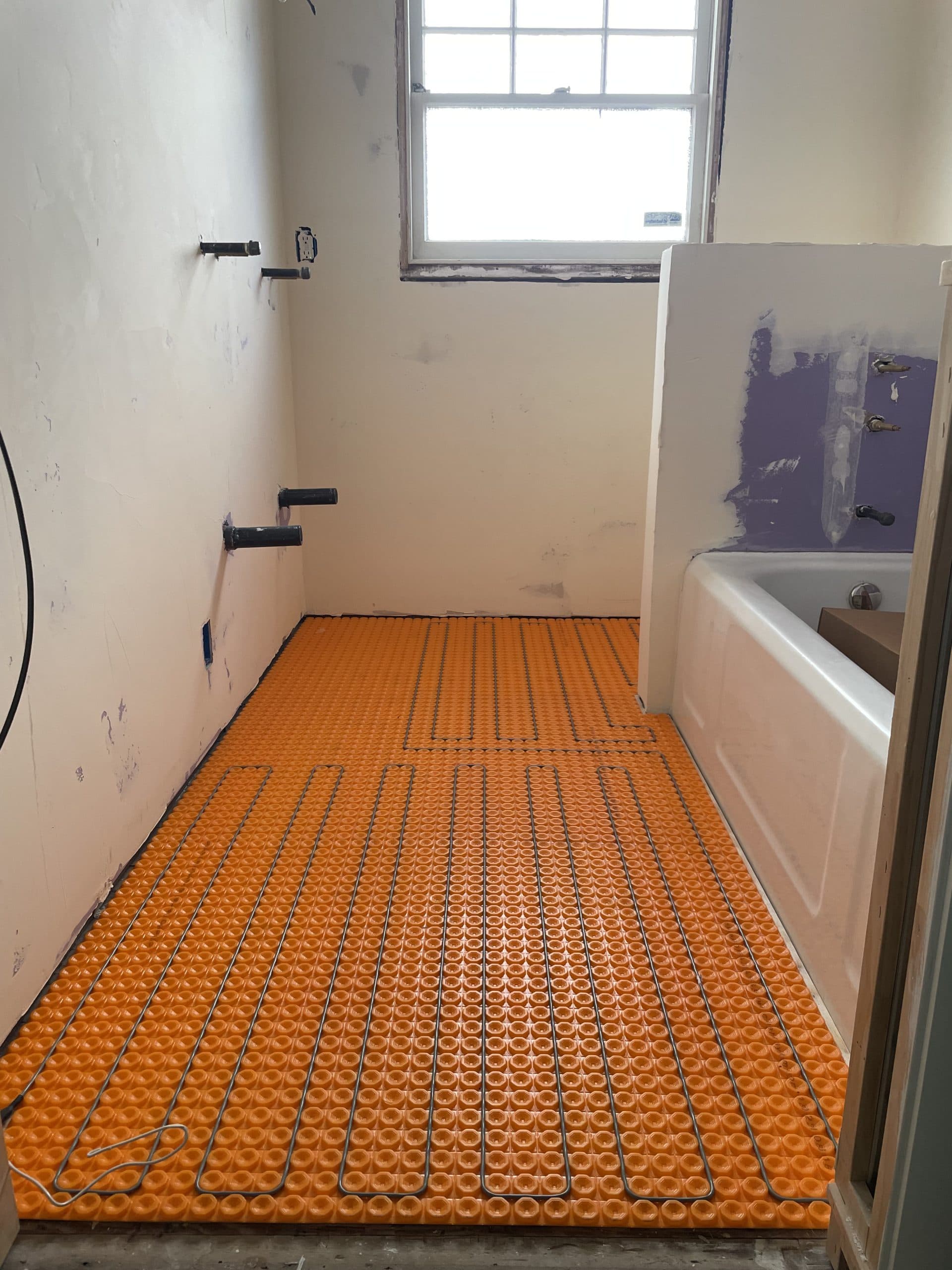 Radiant heat mat installed around fixtures in Carmichael bathroom renovation